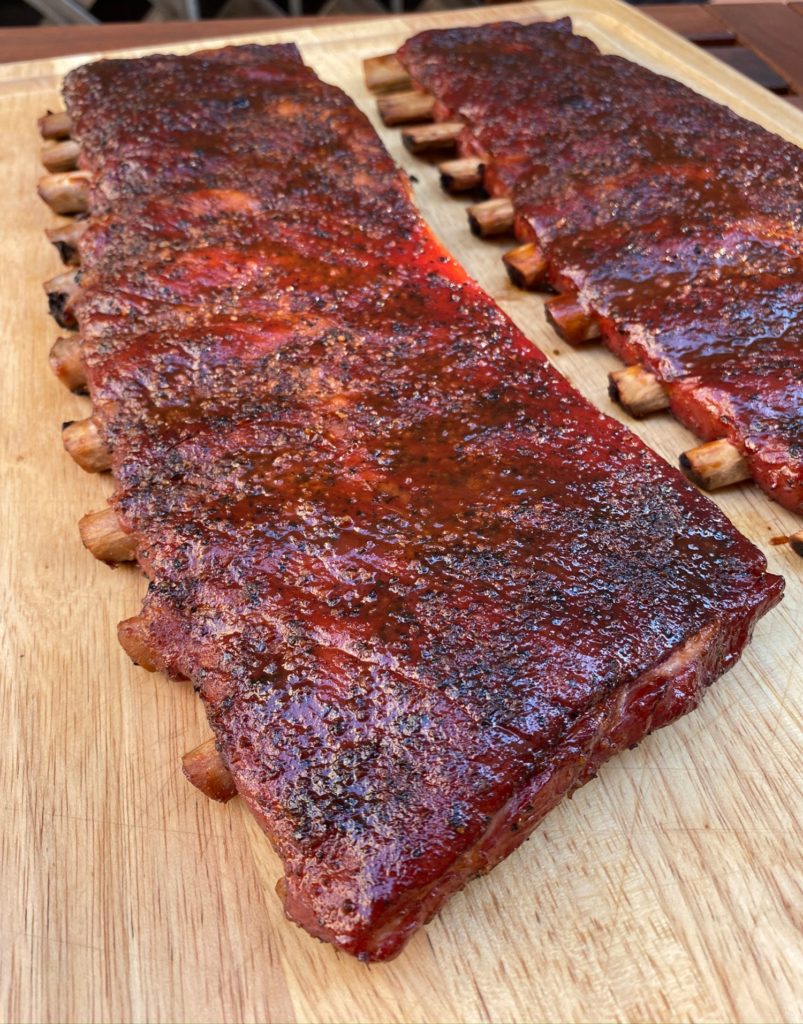 2 racks of st louis style ribs on a cutting board
