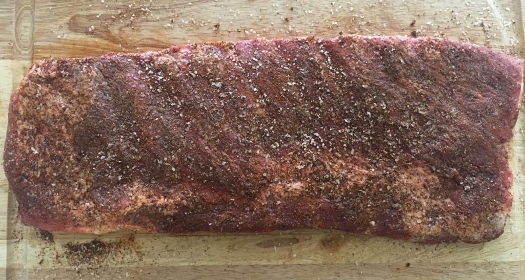st louis style ribs seasoned with dry rub on a cutting board
