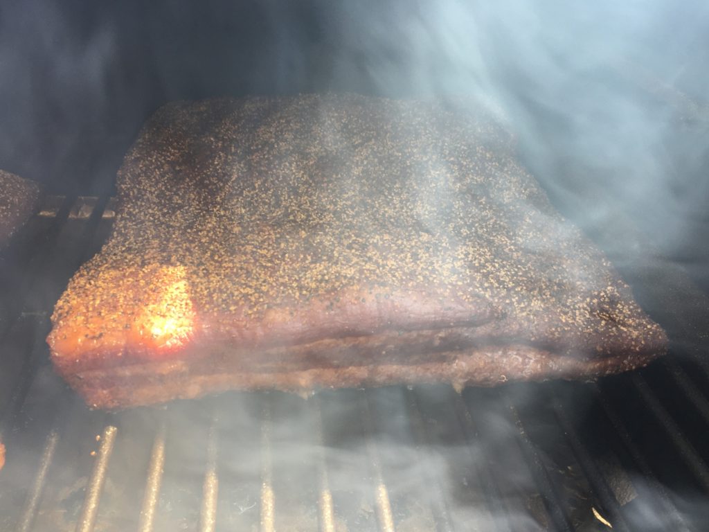 black pepper bacon in a smoker